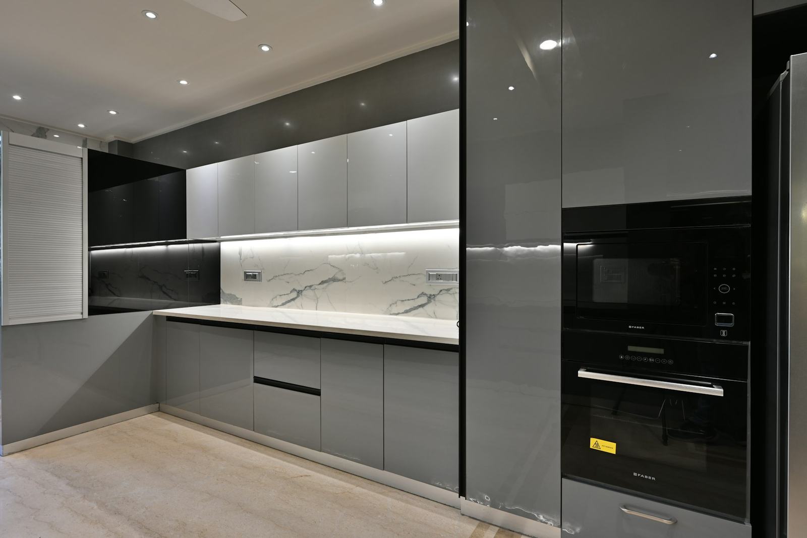 Grey modular kitchen with a marble backsplash